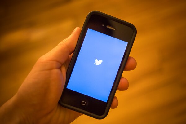 Twitter's splash screen appears on a mobile phone.