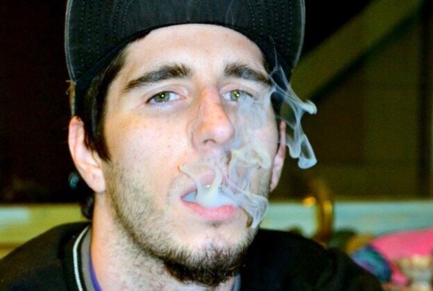 Luke Uteck blows smoke as he remembers his time in prison