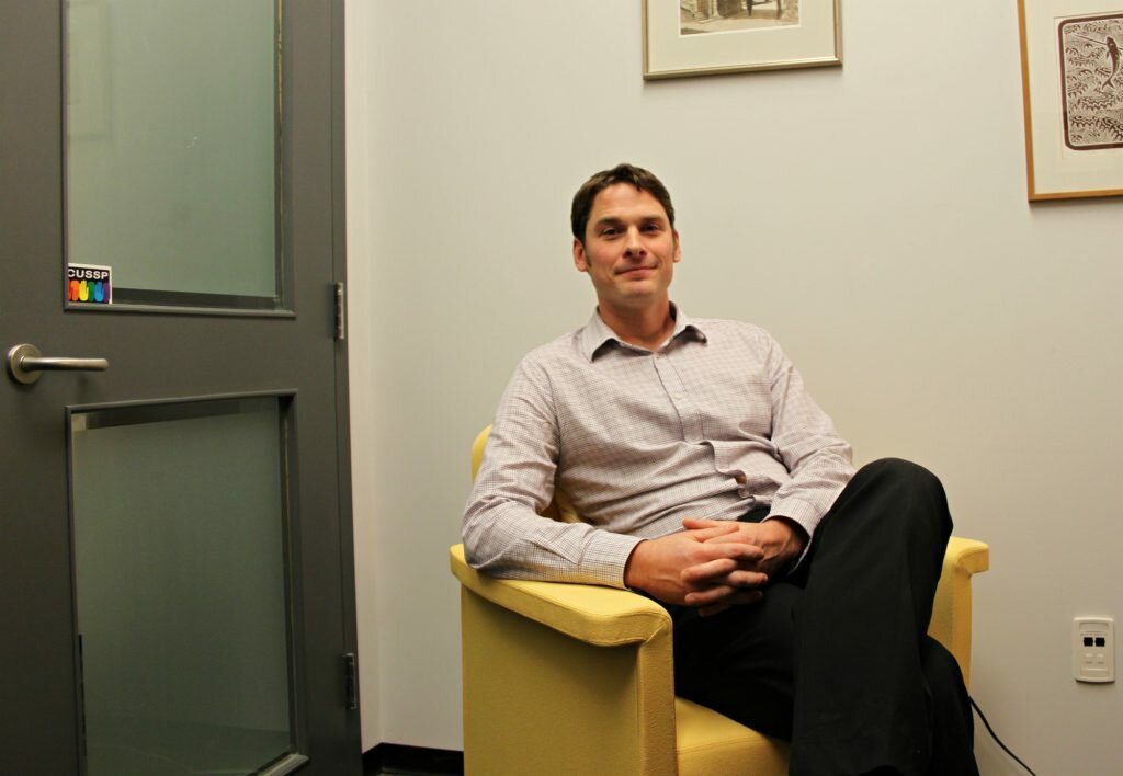 Nathaniel Jewitt, a counsellor for Carleton's Health and Counselling services helps students in residence who might be dealing with anxiety and depression. He's pictured here in his office. Photo by Olivia Bowden.
